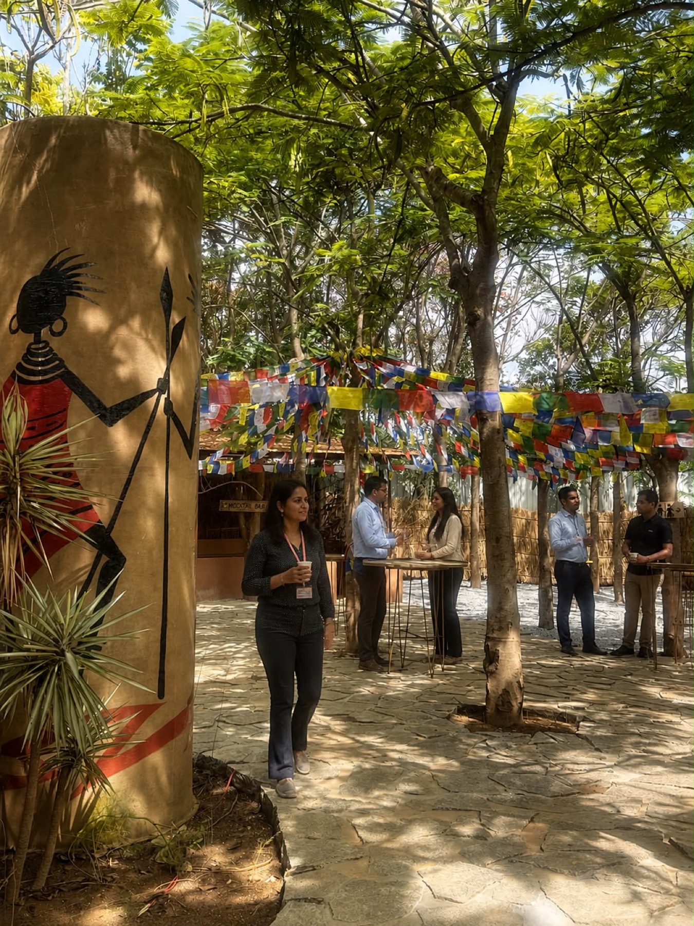 Colleagues at an outdoor breakout under prayer flags at Orchid Tree