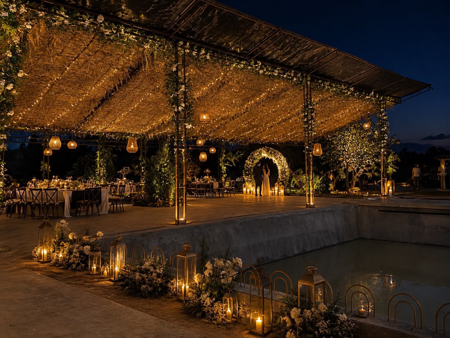 A wedding mandap under a canopy of warm fairy lights beside the Orchid Tree pool, lit by lanterns and candles